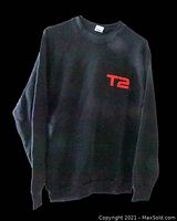 Front of black crewneck sweatshirt with red T2 logo on chest