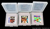Three Nintendo Gameboy cartridges (Castlevania Adventure, WWF Superstars, Gargoyles Quest) in clear plastic cases photographed side-by-side.