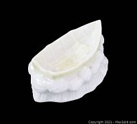 Front angled view of vintage Belleek fine Irish porcelain boat dish showing detailed sculpted design and glossy finish.