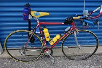 Full right-side view of bicycle showing frame, wheels, bottles and accessories