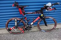 Full side view of bike showing frame, wheels, aerobars and accessories