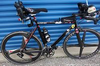 Full side view of bicycle showing frame, wheels, handlebars, and accessories