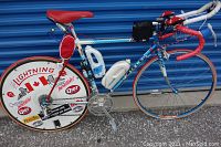 Full left-side view of bicycle leaning against storage unit