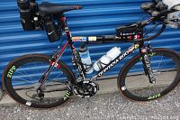 Side view of entire bicycle showing frame, wheels, saddle and mounted accessories.