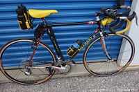 Full side profile of bicycle showing frame, wheels, saddle and accessories