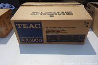 Closed original shipping box showing TEAC A-X3000 branding and handling instructions