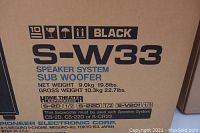Photo of the original cardboard box for Pioneer S-W33 subwoofer system showing model and weight specifications.