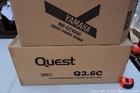 Two stacked boxes showing the Yamaha NS-CC100C and Quest Q3.6C speaker product names and details.
