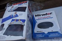 Photo showing the Rainier Multi-Use sleeping bag box and the Mirador electric cooking plate box side by side.