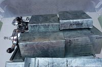 Plastic bin containing multiple silver Dura-Ace component boxes and two polished brake calipers.