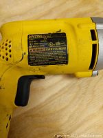 Close-up of Dewalt drill label showing model DW235G and electrical specifications.