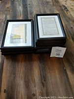 Stacked small black frames showing edges and size approximately 9 x 6.5 inches