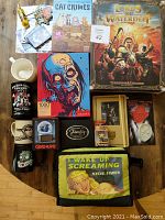 Full lot overview on wooden floor showing various games, mugs, puzzle, and pop culture items.