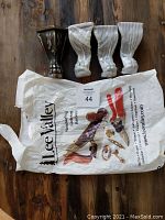 Four iron claw feet and the original Lee Valley packaging bag, showing the lot items and seller brand.