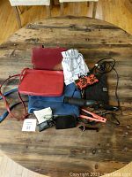 Overview of all items on wooden table showing purses, hair tools, pillowcases, and other accessories