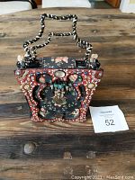 Front view of the ornately beaded Mary Frances evening bag with floral fabric and beaded handle.