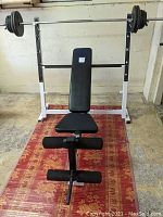 Full front view of bench with barbell and weight plates loaded