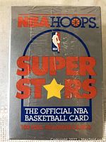 Front of sealed gray box with NBA Hoops Super Stars logo and text 'The Official NBA Basketball Card, 100 NBA Trading Cards'.