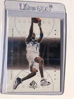 Front of Tracy McGrady NBA card showing player in Orlando Magic jersey leaping with ball.