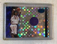 Front of Chris Bosh basketball card with holographic design and purple jersey piece embedded