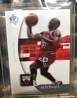 Front of Michael Jordan Chicago Bulls basketball card showing player in red uniform jumping to shoot with basketball. SP Authentic and Chicago Bulls logos visible.