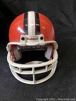 Front view of the miniature Cleveland Browns helmet with white face mask and vertical stripes.