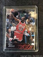 Front of Michael Jordan basketball card in red Chicago Bulls uniform, showing Upper Deck logo and signature.