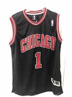 Front view of black Chicago Bulls basketball jersey with Derick Rose number 1 and Chicago text.