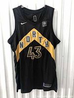 Front view of black Toronto Raptors jersey with 'NORTH' chevron and number 43.
