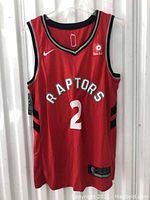 Front view of red Toronto Raptors basketball jersey showing number 2 and Nike and Sun Life logos