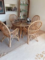 Front view of entire set with round wicker table and four wicker chairs