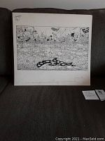 Photo showing full view of original drawing with boats, fish, and hand notes on matting.