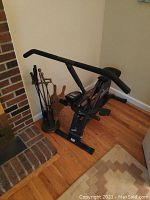 Full view of the HealthRider stationary bike positioned next to a fireplace on a hardwood floor.