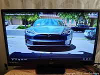 Photo showing the Sanyo HDTV powered on, displaying a clear image of a Tesla Model S Plaid video.