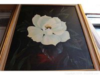 Painting of a large white flower on dark background with Rhodes signature.