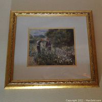 Framed lithograph print titled "Picking Flowers" by Renoir, showing an image of two figures in a flower garden with white matting and a gold decorative frame.