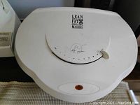 White George Foreman Lean Fat Grilling Machine grill top view with adjustable dial and red indicator light