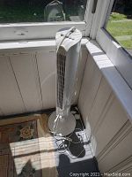 Lasko 24 inch tower fan, slim white vertical fan with front grille and power cord at base