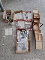 Overview of paint sets, brushes, painting guides, and the wooden storage box components.