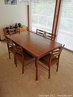Full view of teak veneer table with six chairs around
