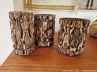 Set of three vintage turned ponga tree fern wood vases on wooden surface with tape measure showing height approximately 6 to 7 inches.