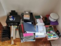 Wide shot showing overall lot with printer, file organizers, folders, papers, stationery items and boxes