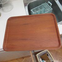 Top view of the teak tray showing its smooth finish and rounded edges.