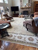 Full room view showing rug under seating furniture on hardwood floor