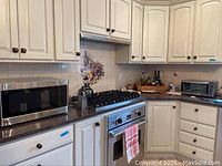 Kitchen counter with two appliances: Hamilton Beach toaster oven to the right and LG microwave to the left.