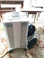 Front view of the IQAir unit with two desk fans