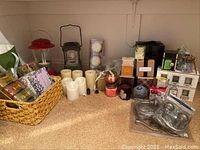 Overview of candles, soaps, lanterns, and metal holdbacks displayed on carpeted floor