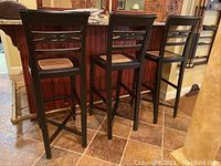Front view of all three matching barstools at counter