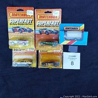 Photo showing five sealed Matchbox Superfast vehicles in original packaging including two 1983 Ford Sierra XR4Ti, one 1985 Escort Cabriolet XR3i, one 1983 Mazda IMSA RX7, and one 1986 Volvo container truck.