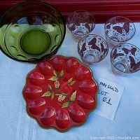 Photo showing the entire set including red royal doulton deviled egg platter, olive green glass bowl, and set of four butterfly decorated rocks glasses.